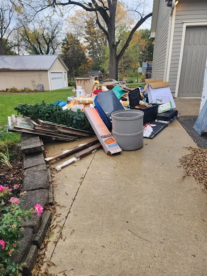 Dumpster being loaded with debris for Roofing Dumpster Rental in Jersey Village
